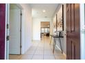 Bright entryway with tile flooring and modern decor at 7049 Oakwood St, Davenport, FL 33837