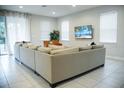 Spacious living room with large sectional sofa and TV at 7420 Marker Ave, Kissimmee, FL 34747