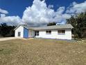 House exterior showcasing a blue and white color scheme and double doors at 7313 Cabor Ct, Orlando, FL 32818