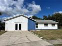 Front view of a ranch-style home with a blue and white color scheme at 7313 Cabor Ct, Orlando, FL 32818