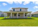 Two-story house with covered patio and grassy backyard at 2993 Water Clover Ct, Apopka, FL 32712