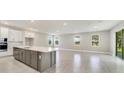 Open concept kitchen with an island and stainless steel appliances at 2993 Water Clover Ct, Apopka, FL 32712