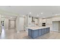 Modern kitchen with a large island and white cabinets at 2993 Water Clover Ct, Apopka, FL 32712