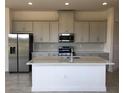 Modern kitchen with island, stainless steel appliances, and white cabinets at 2323 Datura Loop, St Cloud, FL 34772