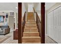 Indoor view of wooden staircase with dark brown railings at 214 Krider Rd, Sanford, FL 32773