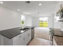 Modern kitchen with stainless steel appliances and granite countertops at 1357 Current Pl, Haines City, FL 33844
