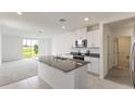 Open kitchen featuring granite island and stainless steel appliances at 1357 Current Pl, Haines City, FL 33844