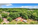 Aerial view of a house on a wooded lot with a shed at 5136 Mcdonald Rd, Zellwood, FL 32798