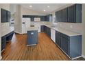 Spacious kitchen with an island, dark cabinetry, and wood-look flooring at 205 Hibiscus St, Winter Haven, FL 33881
