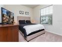 Cozy bedroom with a queen-size bed and window at 2429 Dubai St, Kissimmee, FL 34747