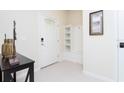 Entryway with built-in shelving and coat closet at 2429 Dubai St, Kissimmee, FL 34747