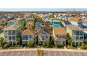 Aerial view showcasing a community of colorful, two-story homes at 2956 Salted Rim Rd, Kissimmee, FL 34747