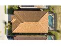 Top-down view of house showing tile roof and screened-in pool at 5300 Oakbourne Ave, Davenport, FL 33837