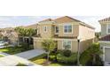 Two-story house on a tree-lined street with a tan exterior and tile roof at 5300 Oakbourne Ave, Davenport, FL 33837