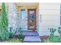 Modern front door with stone accents and landscaping at 9832 Bucklow Hill Dr, Orlando, FL 32832