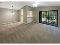 Spacious living room with a neutral color palette and carpeted floor at 196 Riverbend Dr # 204, Altamonte Springs, FL 32714
