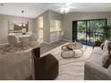 Open living room and dining area with access to a balcony at 196 Riverbend Dr # 204, Altamonte Springs, FL 32714