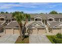 Complex of tan townhomes with garages and lush landscaping at 9422 Myrtle Creek Ln # 804, Orlando, FL 32832