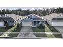 Three-house aerial view showing a neighborhood setting and surrounding landscape at 530 Ellie Ct, Apopka, FL 32703
