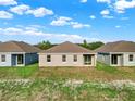 Three-home rear view showing similar design and landscaping at 524 Ellie Ct, Apopka, FL 32703