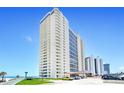 Tall white building with balconies, ocean view, and parking lot at 2545 S Atlantic Ave # 2107-2108, Daytona Beach Shores, FL 32118