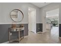 Entryway with mirror, console table, and view into the living area at 4270 Lana Ave, Davenport, FL 33897