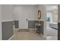 Open entryway with gray and white color scheme and view to the kitchen and bedroom at 4270 Lana Ave, Davenport, FL 33897