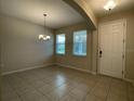 Bright dining room with tile floors and access to the kitchen at 14154 Dove Hollow Dr, Orlando, FL 32824