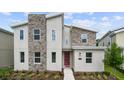 Modern two-story home with stone accents and landscaping at 2726 Oxymoron Way, Kissimmee, FL 34746