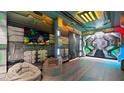 Space-themed game room with bean bag chairs and a large TV at 2726 Oxymoron Way, Kissimmee, FL 34746