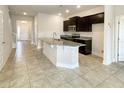 Kitchen with dark cabinetry, granite countertops, and an island at 3654 Sagefield Dr, St Cloud, FL 34773