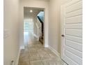 Bright and spacious entryway with tile flooring and staircase at 3654 Sagefield Dr, St Cloud, FL 34773