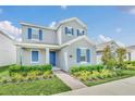 Two-story home with blue shutters and landscaped front yard at 5115 Lake Hamlin Trl, Winter Garden, FL 34787