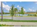 Lakeside at Hamlin community with pond and lush landscaping at 5115 Lake Hamlin Trl, Winter Garden, FL 34787