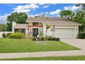 Beautiful home exterior, showcasing landscaping and a two-car garage at 603 Antilla Ave, Altamonte Springs, FL 32714