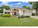 House exterior showcasing landscaping, a two-car garage and an American flag at 603 Antilla Ave, Altamonte Springs, FL 32714