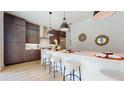 Modern kitchen with a large island and dark brown cabinets at 508 W Swoope Ave, Winter Park, FL 32789