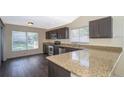 Galley kitchen with granite countertops and stainless steel appliances at 7628 Eldorado Pl, Orlando, FL 32818