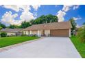 Single-story house with attached garage and well-manicured lawn at 7628 Eldorado Pl, Orlando, FL 32818