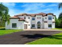 Two-story home with tile roof, double garage and palm trees at 2490 Zuni Rd, St Cloud, FL 34771