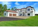 Two-story home with three car garage, paver driveway and landscape at 2490 Zuni Rd, Saint Cloud, FL 34771