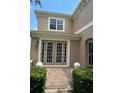 House entrance with double doors, brick walkway, and manicured landscaping at 2211 Rickover Pl, Winter Garden, FL 34787