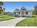 Gray house with white door and black window trim at 702 S Myrtle Ave, New Smyrna Beach, FL 32168