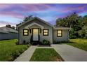 Modern home exterior at dusk with well-manicured lawn at 702 S Myrtle Ave, New Smyrna Beach, FL 32168