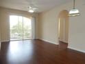 Living room with dark hardwood floors and sliding doors to balcony at 6214 Stevenson Dr # 201, Orlando, FL 32835