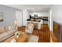 Living room with open concept kitchen, hardwood floors, and modern decor at 4350 Perkinshire Ln # 111, Orlando, FL 32822