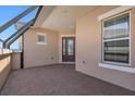 Brick paved covered patio with dark brown door and windows at 737 Alcove Dr, Groveland, FL 34736