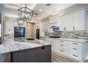 Modern kitchen featuring white cabinets and granite countertops at 17694 Sw 61St Lane Rd, Dunnellon, FL 34432