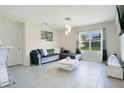 Spacious living room with comfortable seating and backyard view at 1157 Torrente Ln, Haines City, FL 33844