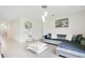 Bright living room features a large sectional sofa and modern coffee table at 1157 Torrente Ln, Haines City, FL 33844